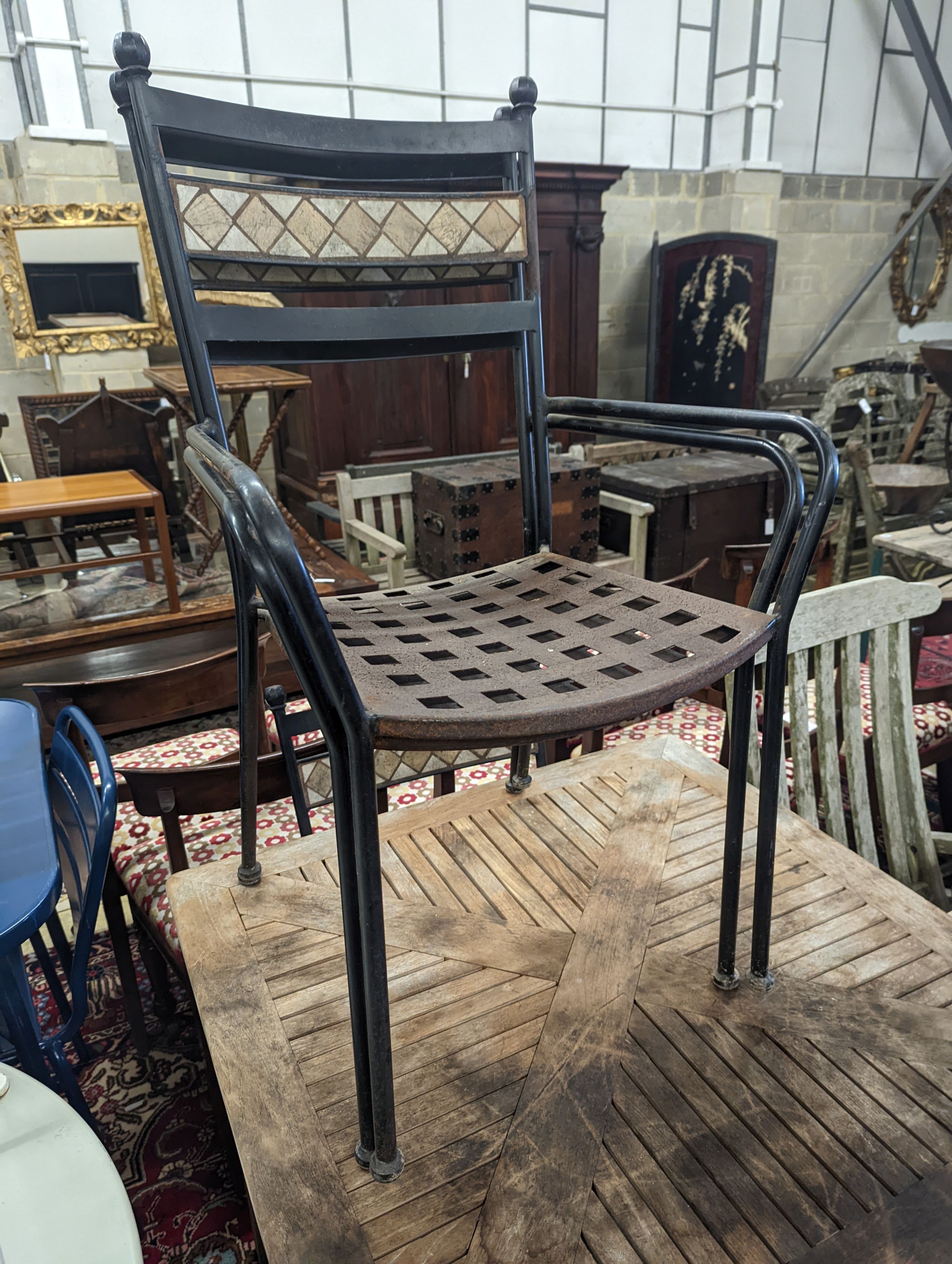 A square teak garden table, width 89cm, height 74cm and four metal garden chairs